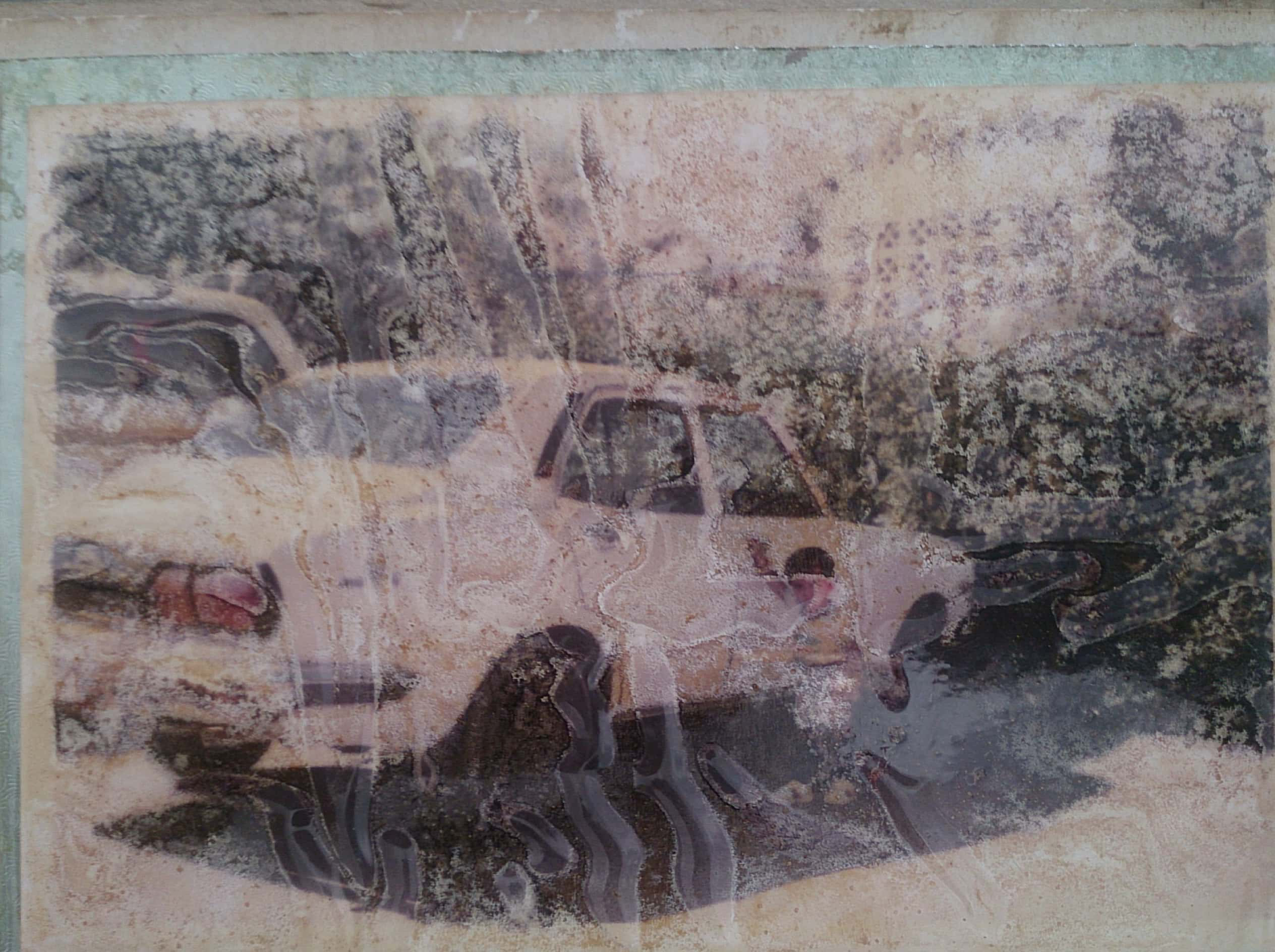 This worn photograph still manage to show a boy by a car. Bada Zayed, 1990